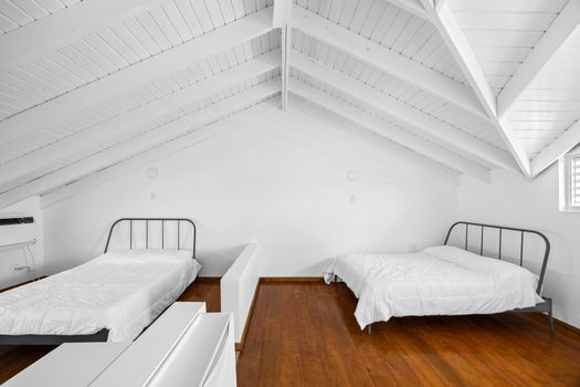 This bright and clean bedroom features twin beds, perfect for a restful night's sleep.