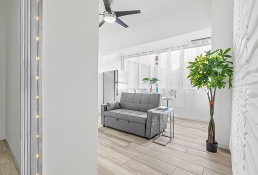 Natural light floods in, illuminating the simplicity of this modern living room.