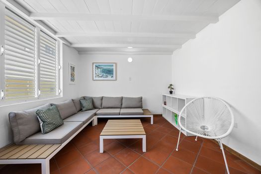 Relax in style in this inviting living room. Featuring a comfortable sectional sofa, perfect for lounging, and a stylish coffee table, this space is designed for both comfort and conversation.
