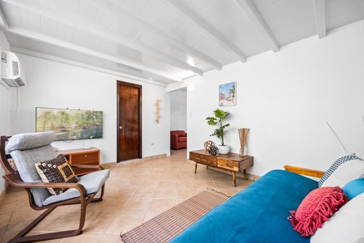 Wind down with your favorite shows in the stylish living room featuring a flat-screen TV and plush seating.