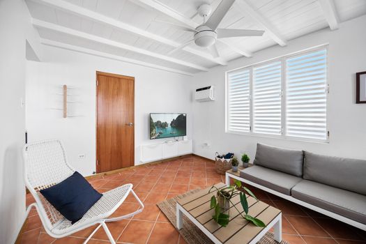 Relaxed island style. A bright and breezy lounge area with comfy seating and cool terracotta floors.