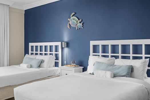 Unwind in a stylish space where comfort meets breathtaking scenery, with two cozy beds and easy access to a balcony that showcases the mesmerizing waterfront.