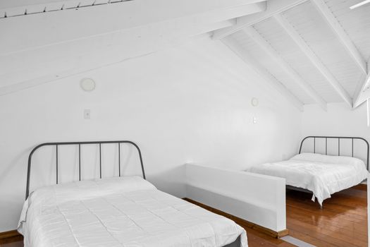 This spacious room features clean lines and ample natural light, creating a serene and inviting space. Perfect for relaxation and rest.