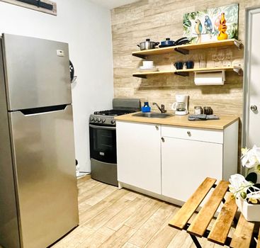 Whip up delicious meals with ease! Our fully-equipped kitchenette includes a gas range, pots, and pans, perfect for home-cooked convenience.