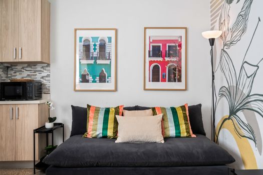Stylish & Connected: This modern living space features a large TV for your entertainment, complemented by vibrant artwork and a comfortable setup perfect for lounging or family time.