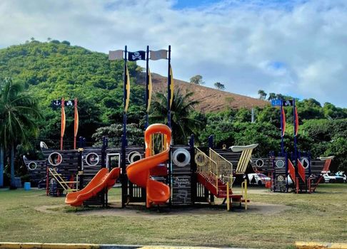 Adventure and culture combine! A fun playground and the iconic Puerto Rico flag monument set against a beautiful backdrop.