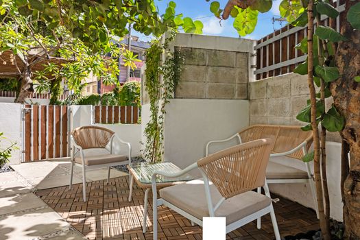 Relax in style at our cozy outdoor lounge with modern tropical chairs perfect for morning coffee or evening cocktails.