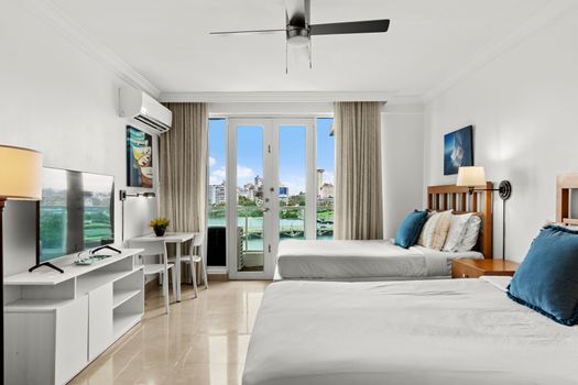 Enjoy bright natural light and a refreshing breeze from the ceiling fan in this cozy space.