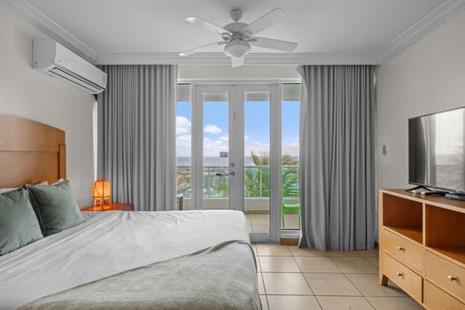 Your tranquil oasis awaits. This spacious studio bedroom connects seamlessly to your private balcony, offering refreshing breezes and stunning water vistas for a truly relaxing stay.