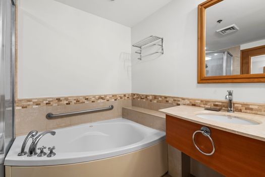Our elegantly designed bathroom features a large vanity with ample counter space and a stylish basin, providing convenience for all your personal items.