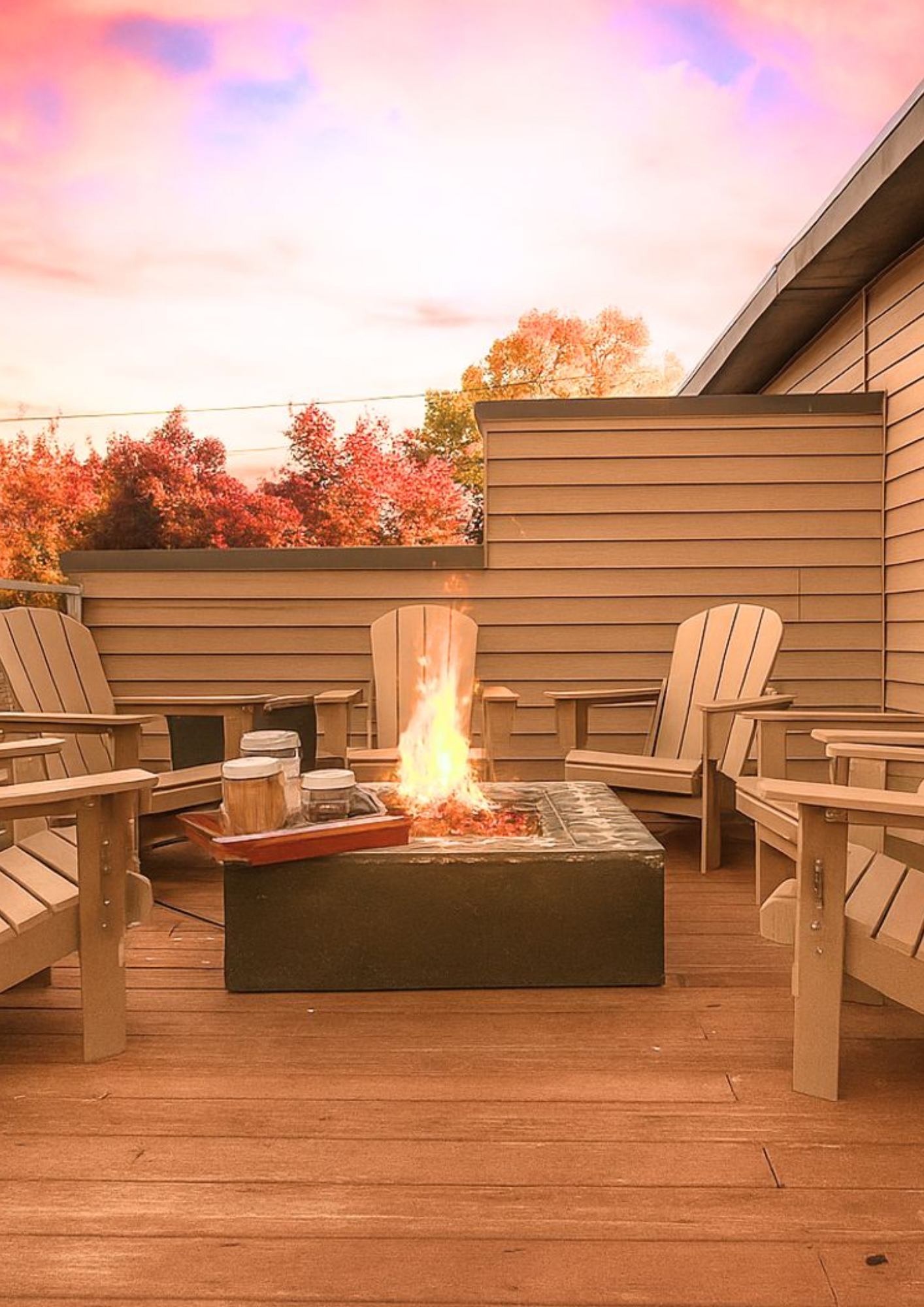 Private rooftop deck with a modern gas fire pit and adirondack chairs at a luxury mountain retreat.