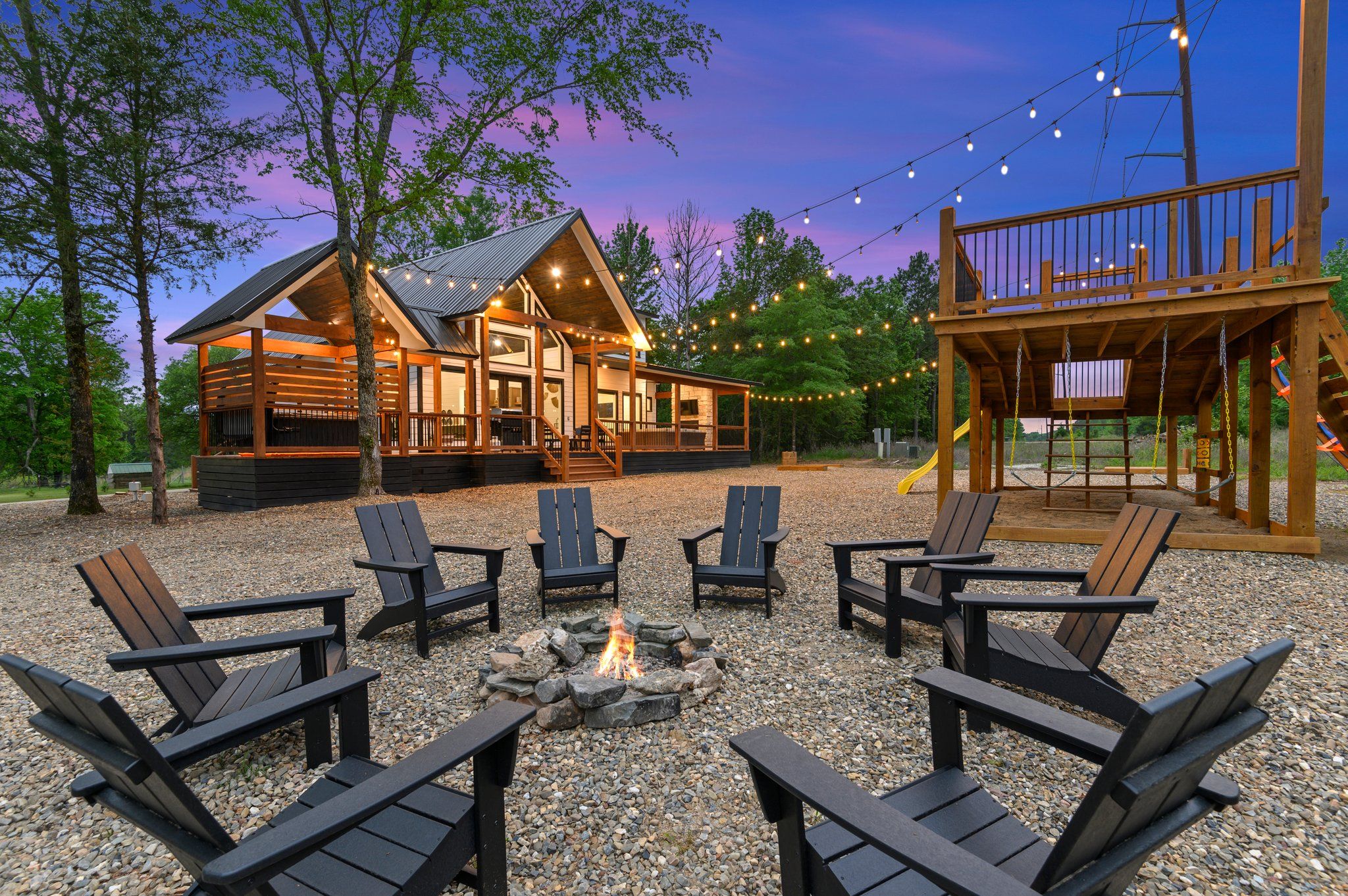 The backyard with a custom playscape and fire pit!