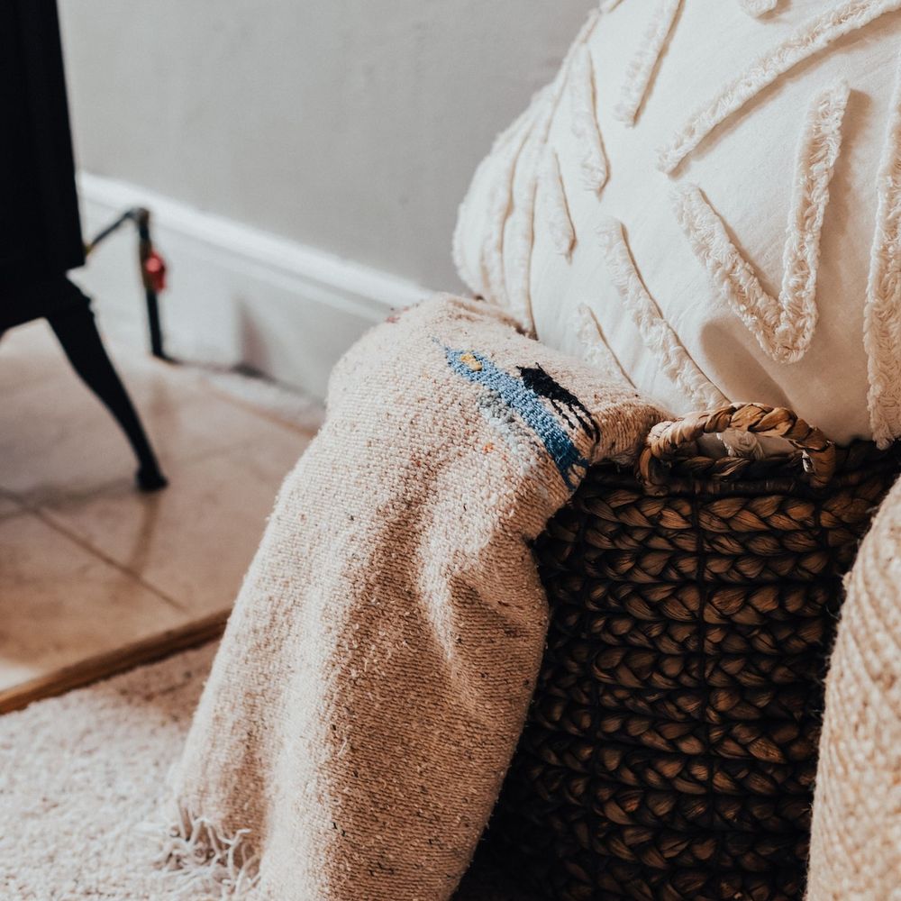 Blankets and floor pillows for lounging by the fireplace