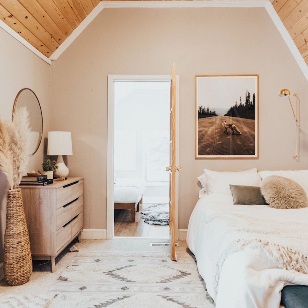 Primary bedroom with bright light and woodsy views