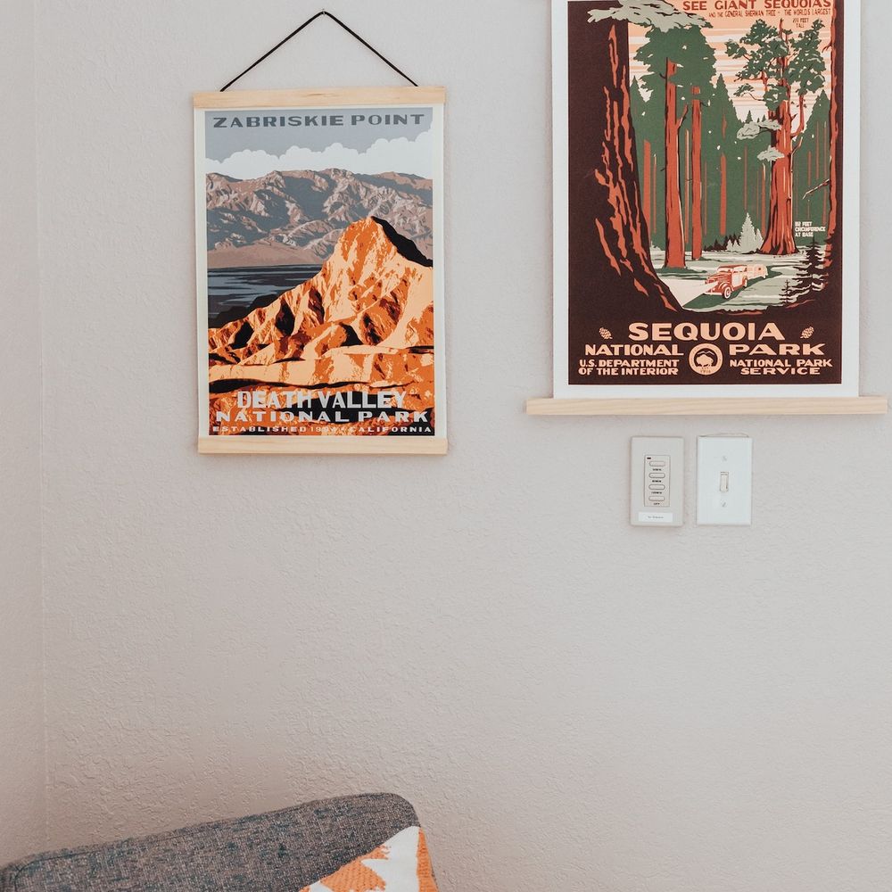 Vintage National Park posters above a comfy rocking chair