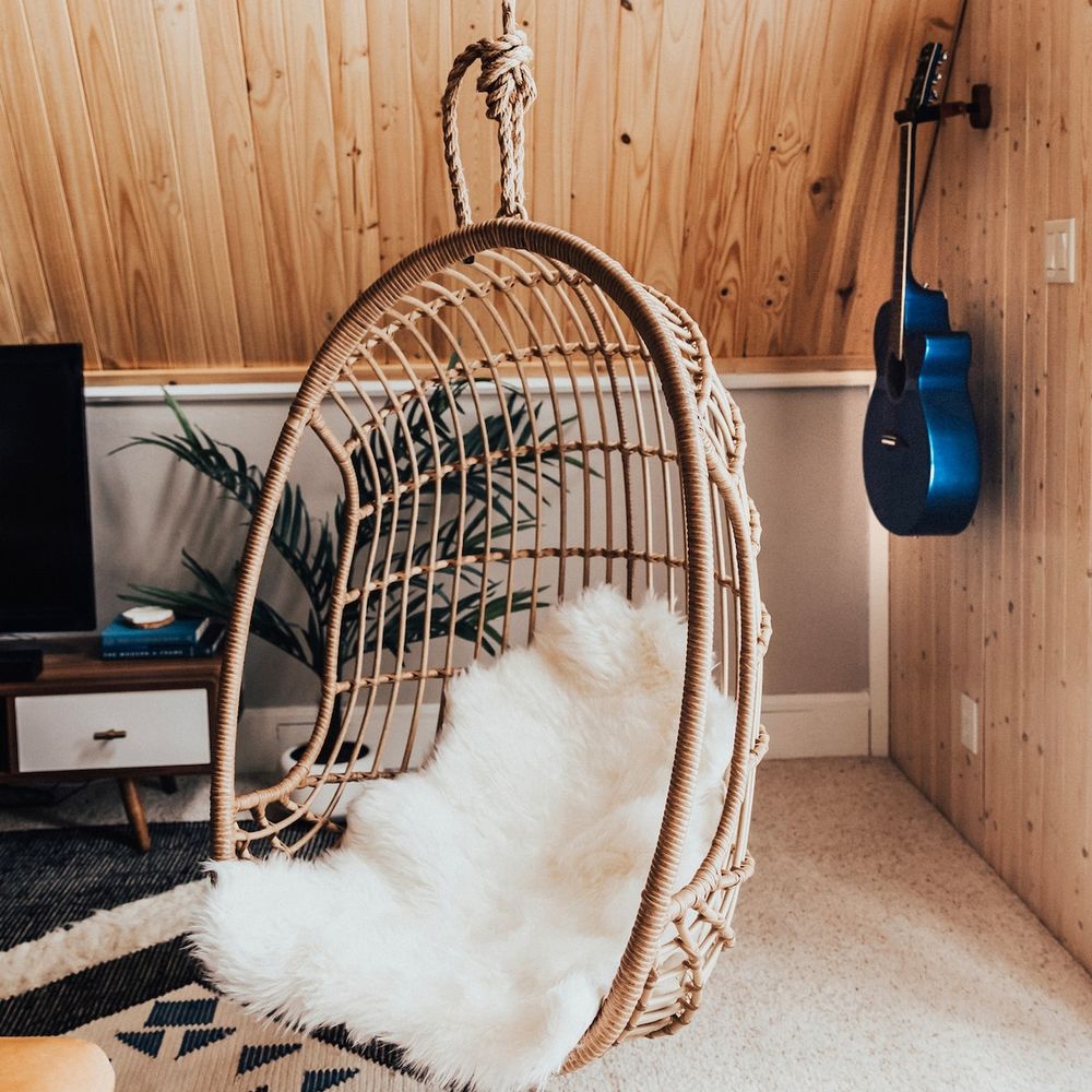 A relaxing egg chair hangs in the main living area