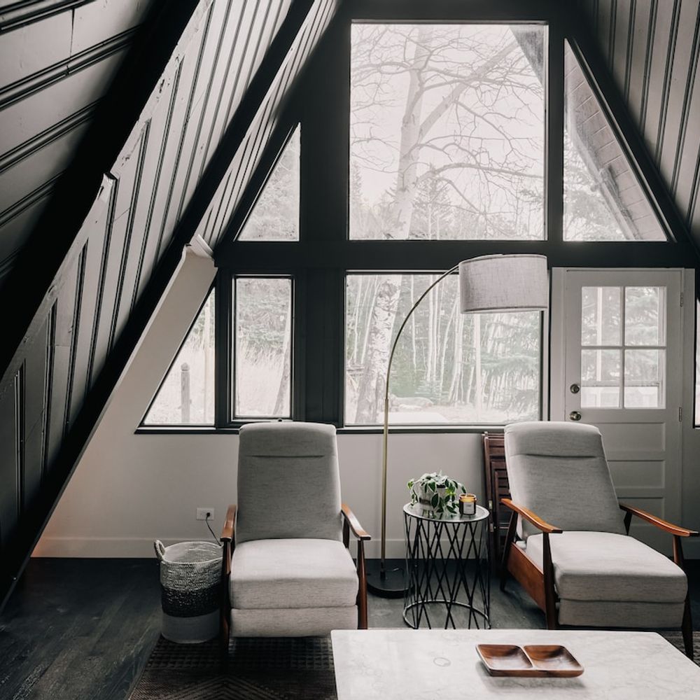Living area looks out to forested area
