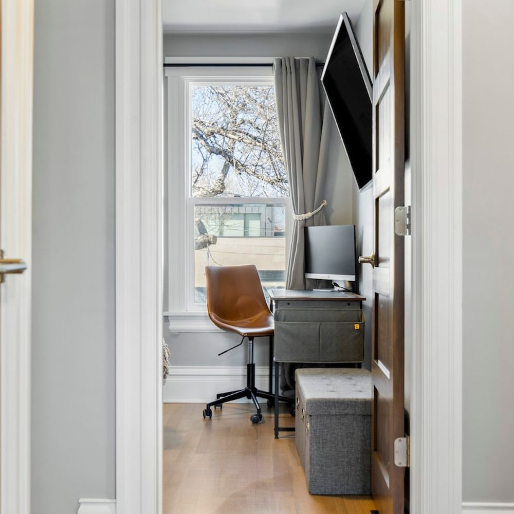 Desk, chair, and monitor in one of the bedrooms