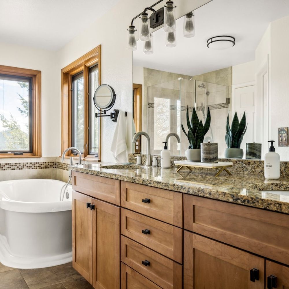 Primary bedroom's private full ensuite bathroom with dual vanities