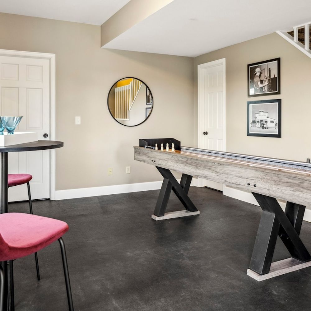 Game room with seating area tabletop shuffleboard