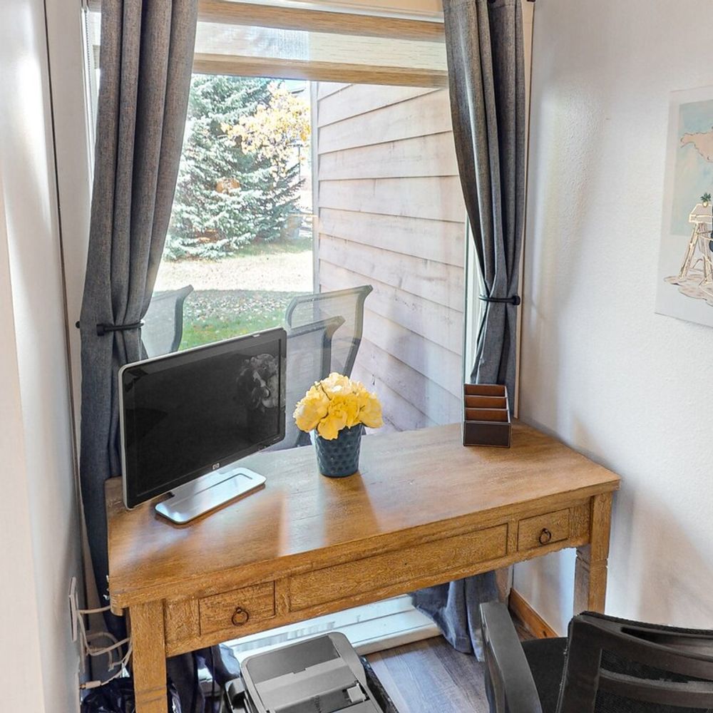 Workspace with desk, chair, monitor, and printer