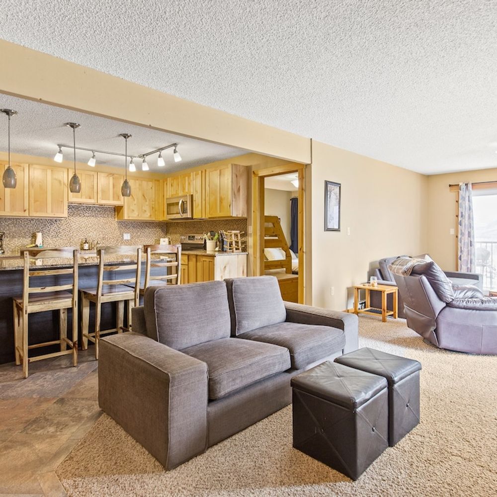 Large living area with seating and open kitchen