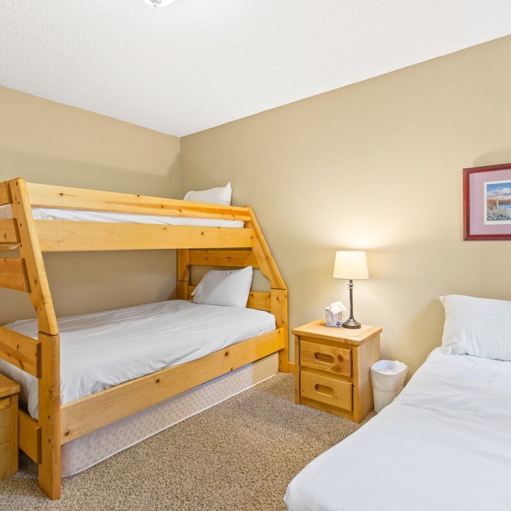 Bedroom 2 with twin over full bunk, twin bed, and twin rollaway