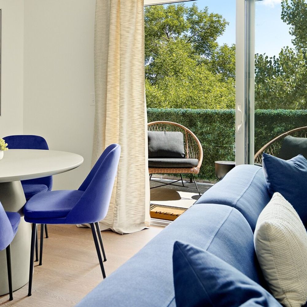 Living and dining area lead to private balcony