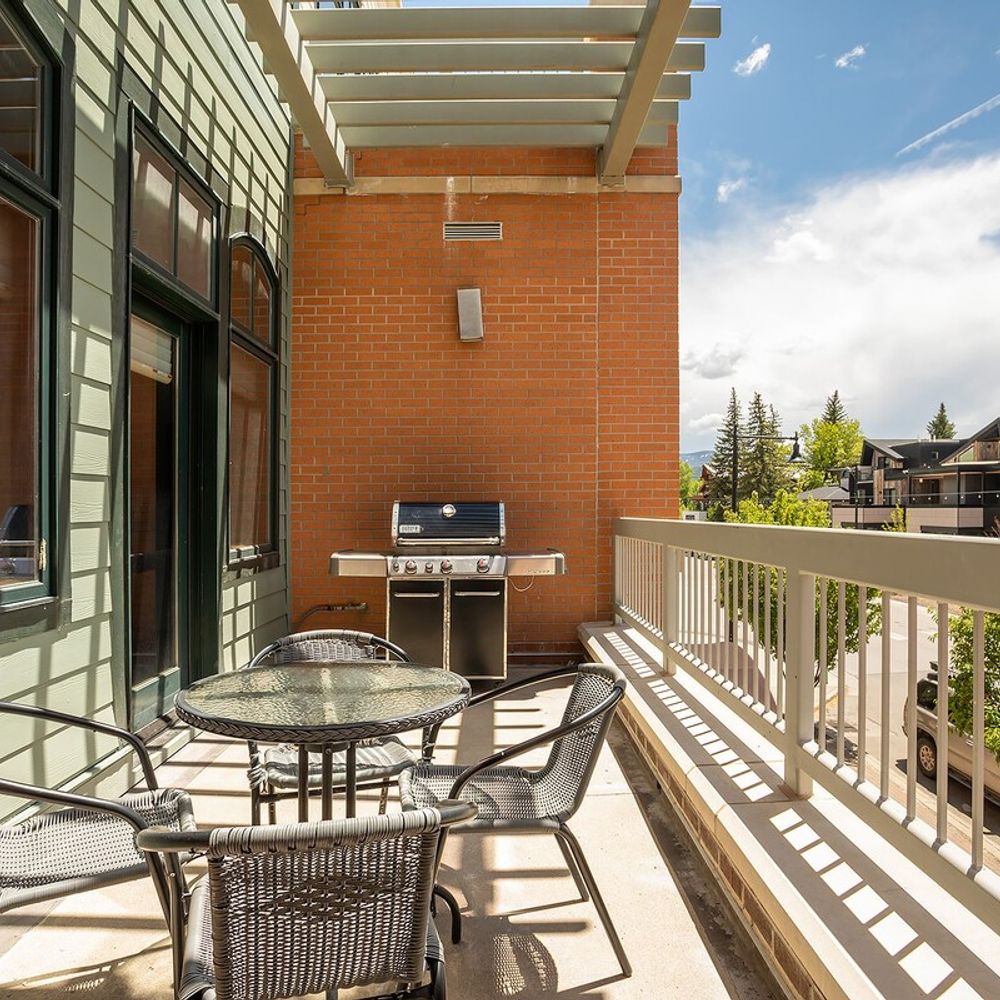 Balcony with seating and gas grill