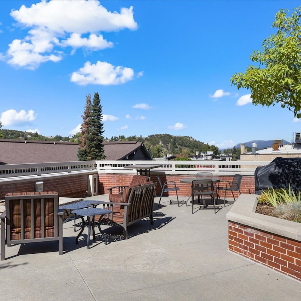 Community patio with fire pit and grill