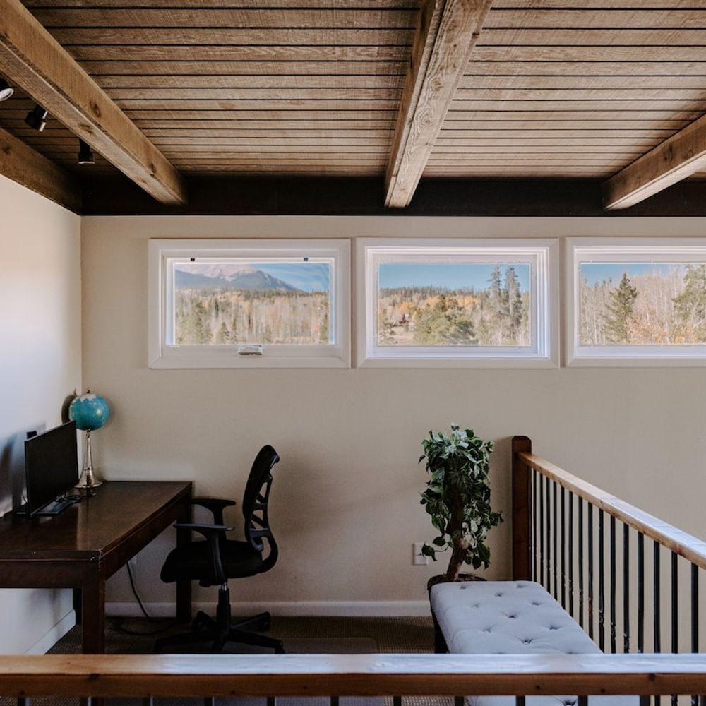 2nd story landing has a desk, chair, and monitor