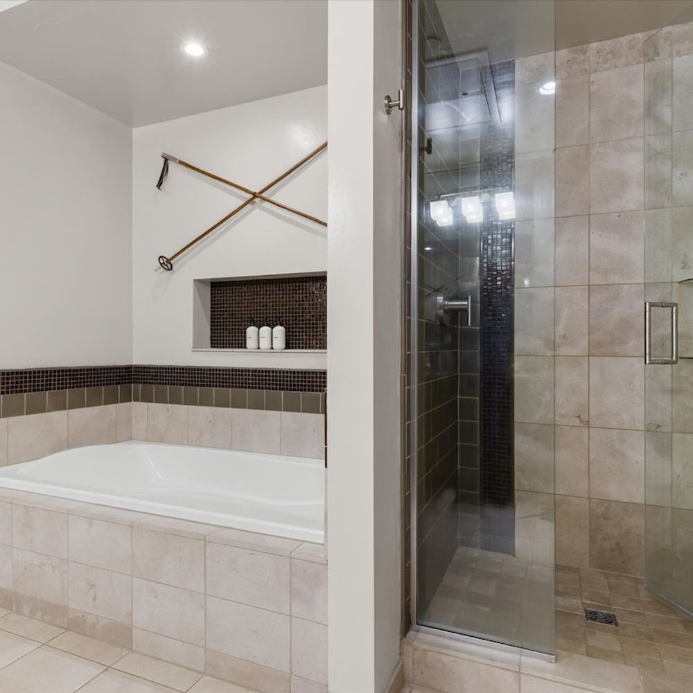 Primary en suite bathroom with tub and separate shower