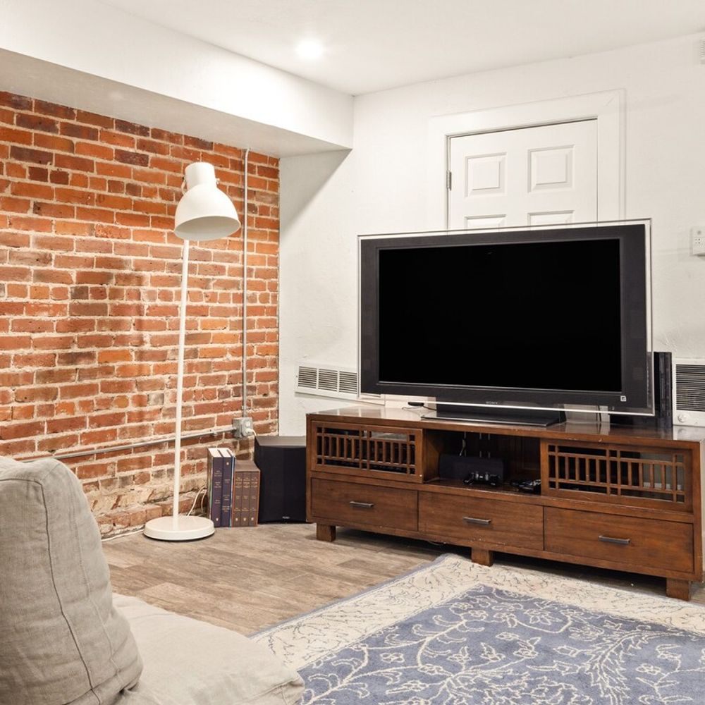 Basement Living Area has a Flat-Screen TV