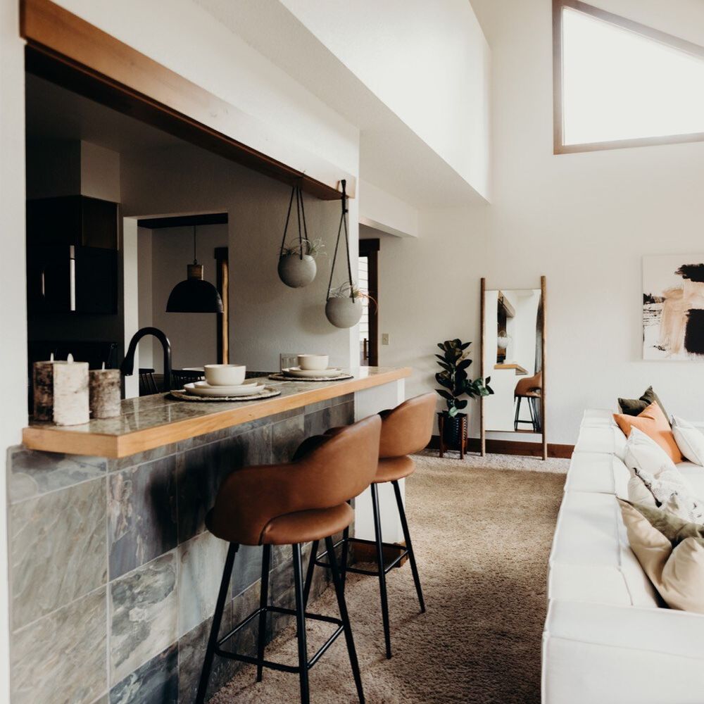 Living room with bar-style seating at the kitchen counter