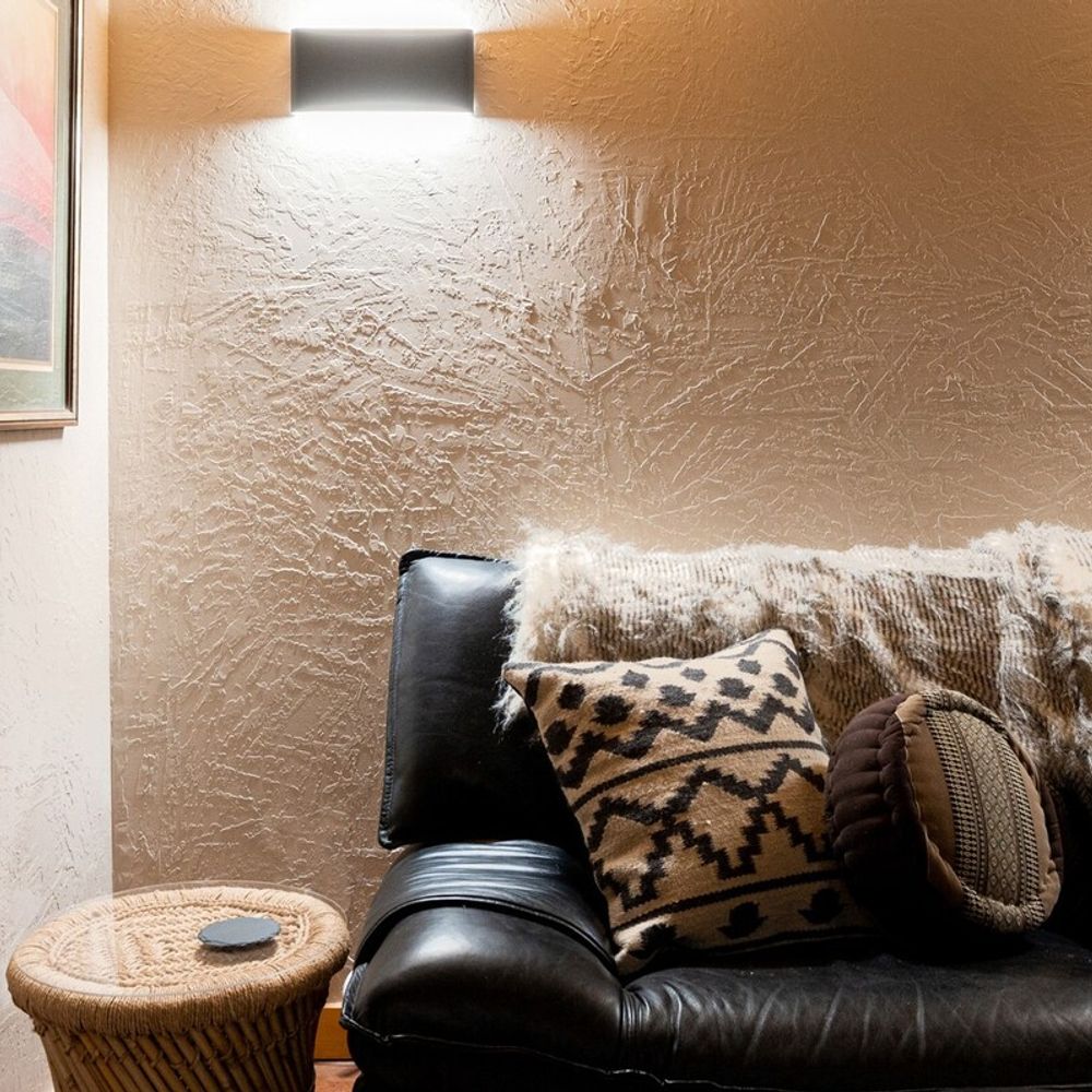 Basement - leather couches add a sleek flair to the rustic basement