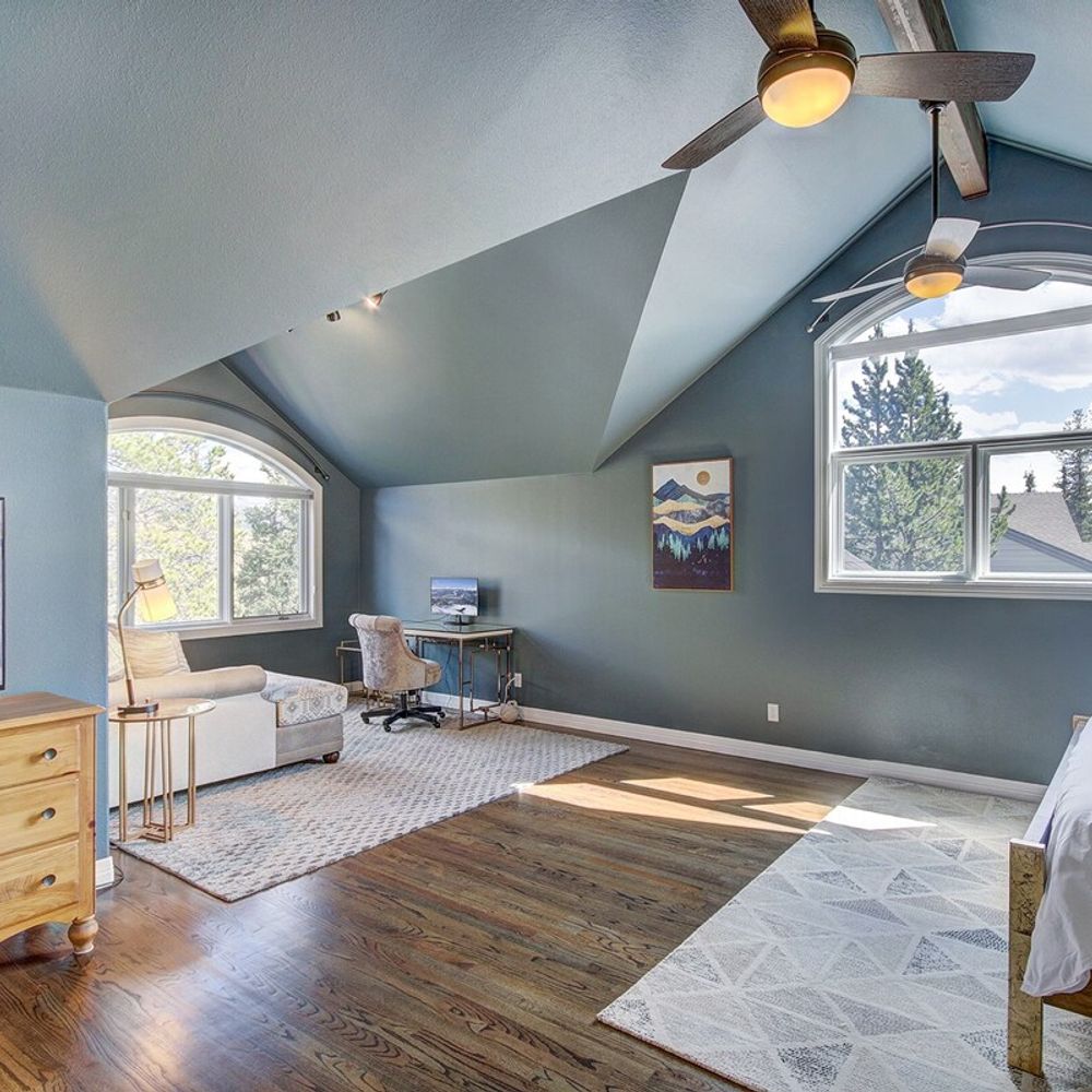 Primary bedroom with king bed and vaulted ceilings