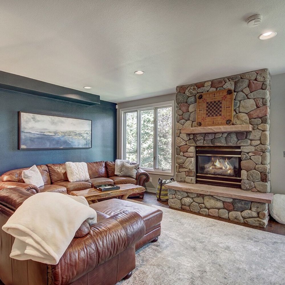 Living area 2 on lower level with leather lounge seating *Please note the lower level fireplace is not currently working*