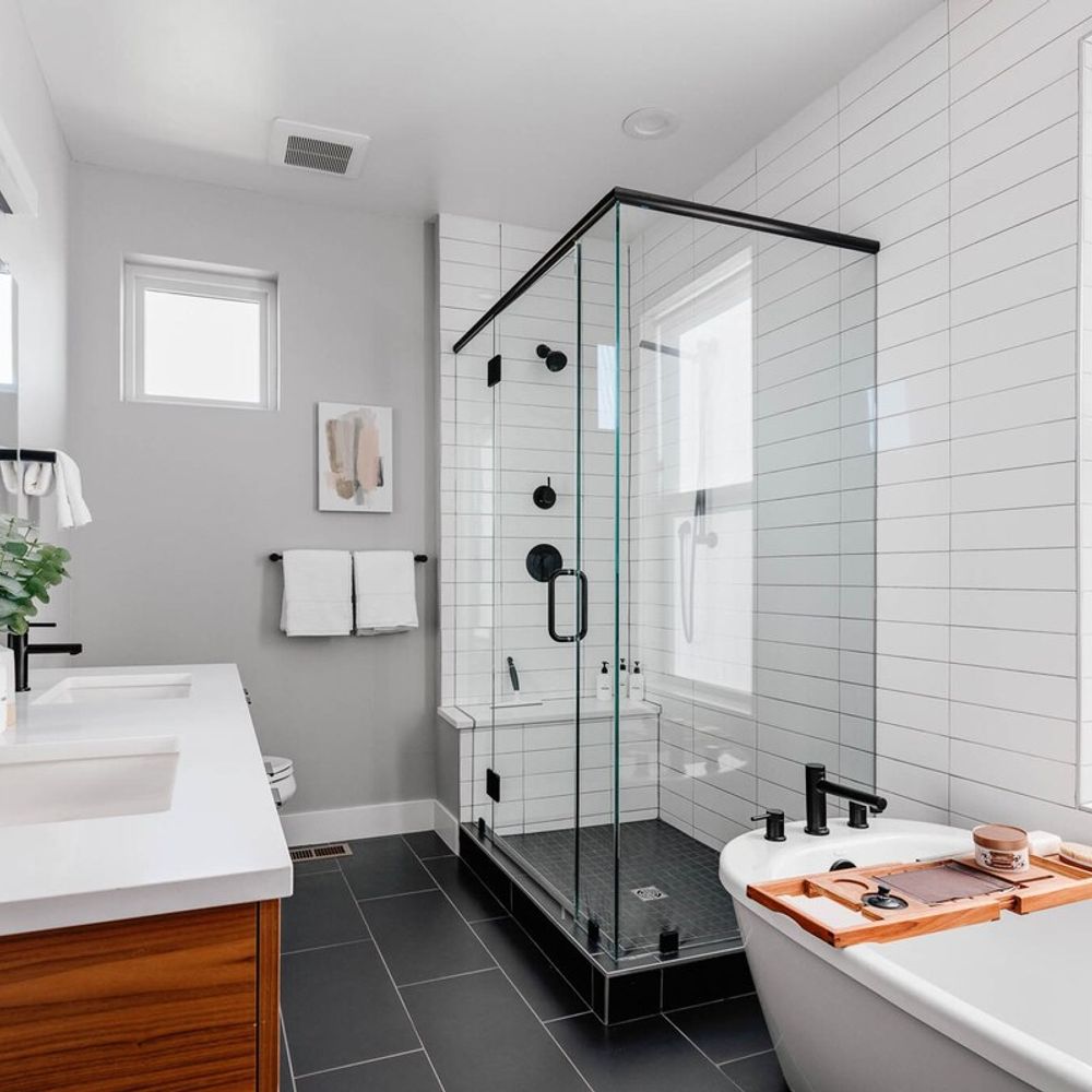 Primary ensuite bathroom with standing shower and free-standing tub