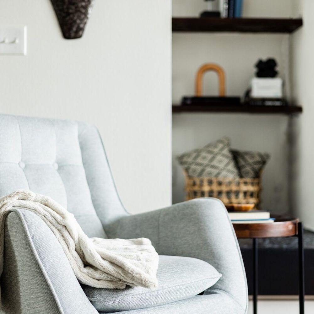 Chair next to fireplace with decor