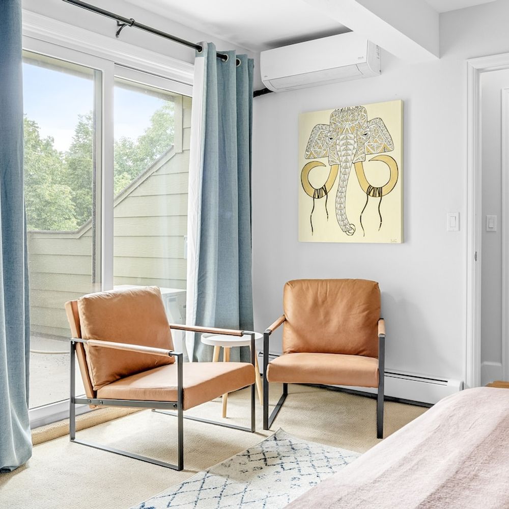 Two chairs and a balcony in the primary bedroom suite