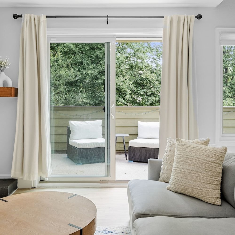 Living area leads to a balcony with two chairs