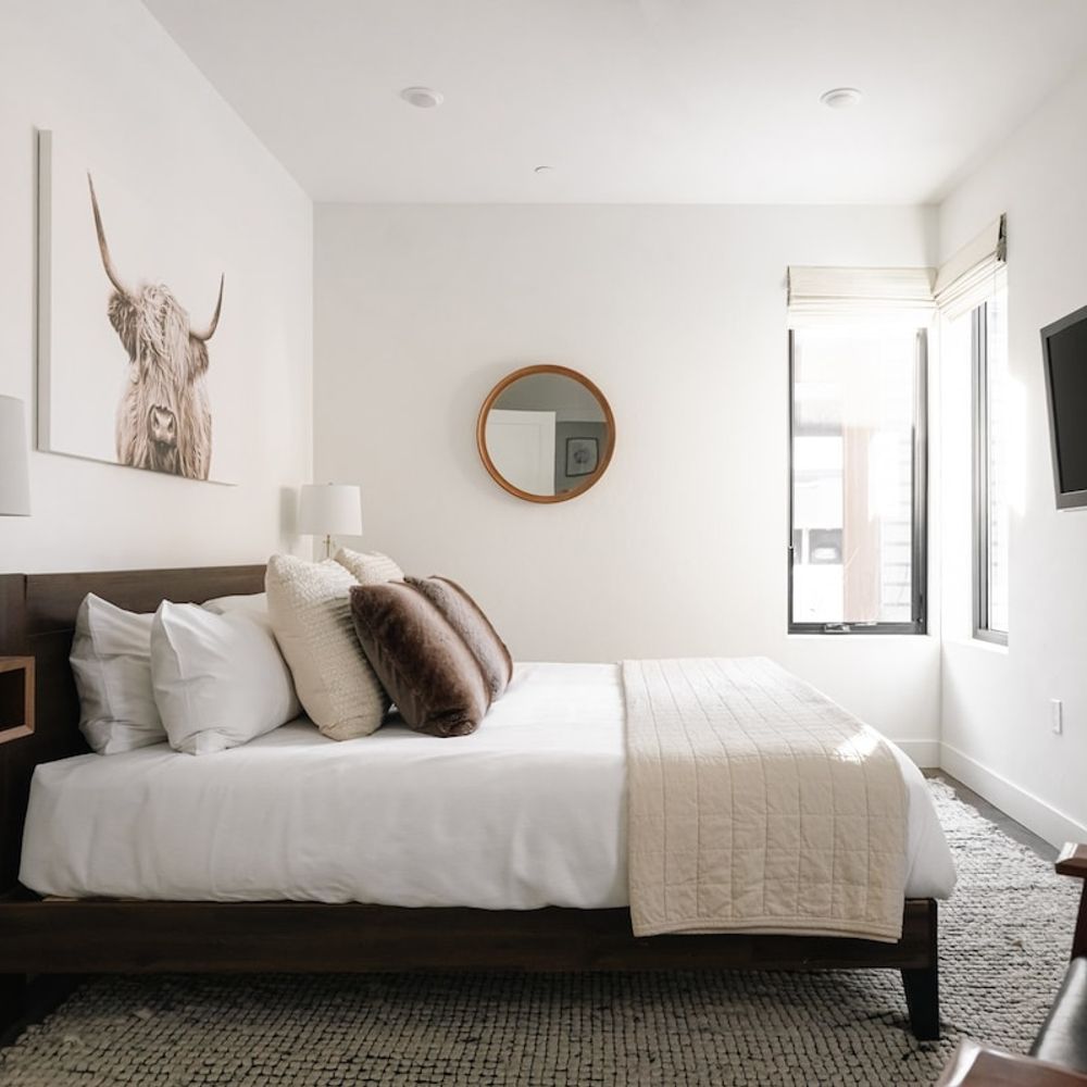 Primary bedroom with king bed, flatscreen TV, and seating area