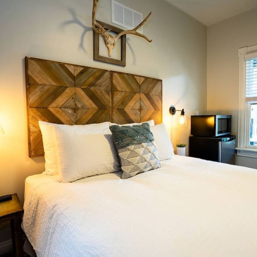 The room includes a microwave and mini fridge