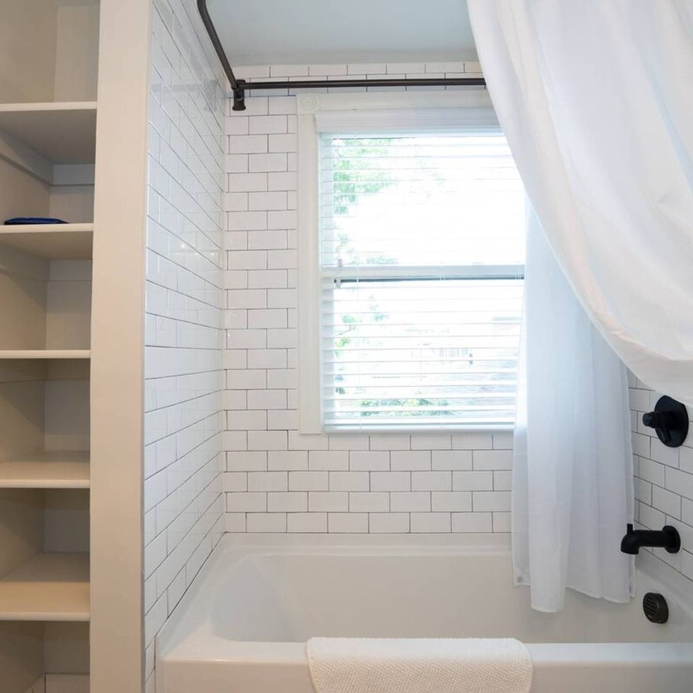 The bathroom includes a shower and bath tub.