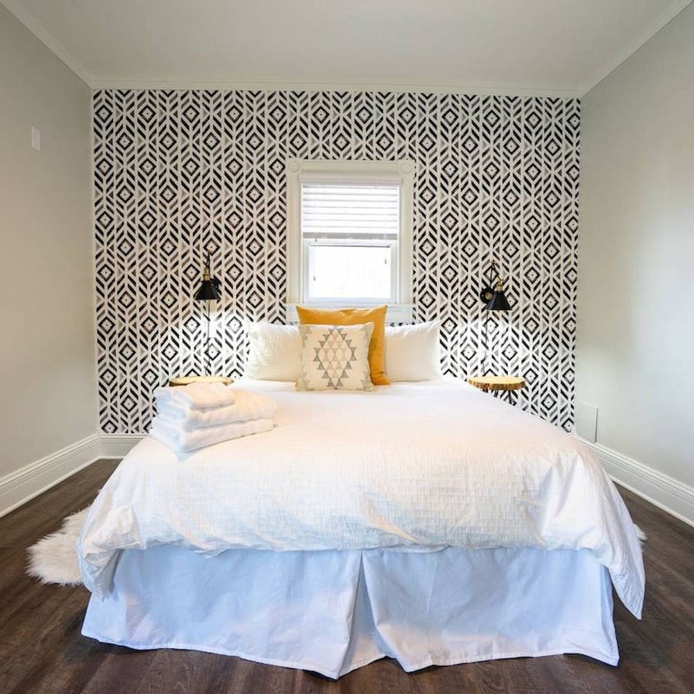 The room features a plush queen bed.