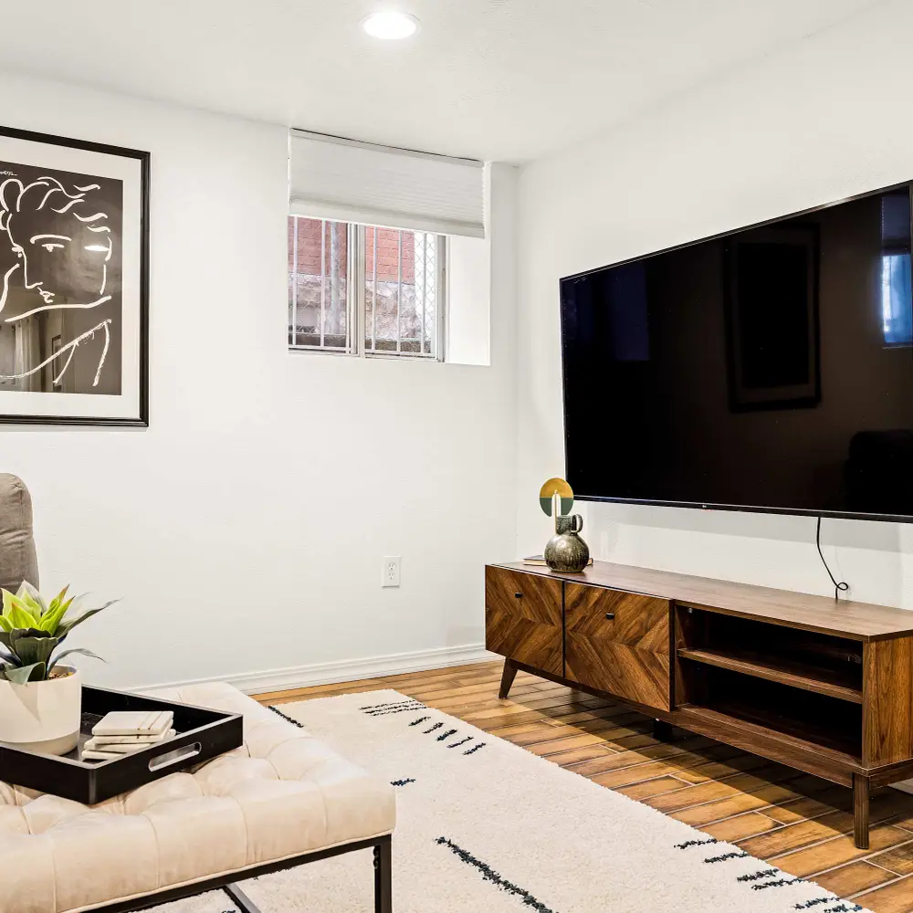 The basement living room has a Smart TV