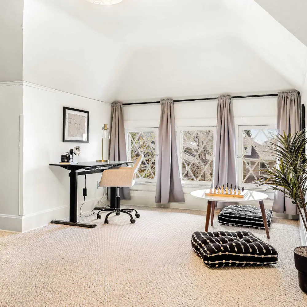 Bedroom 4 has a desk and chair as well as a seating area