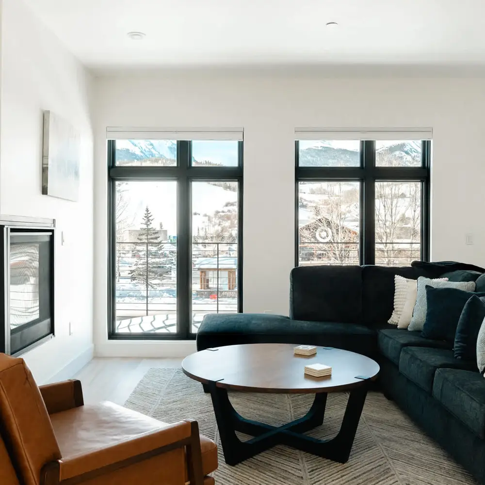 Main living area with gas fireplace and balcony