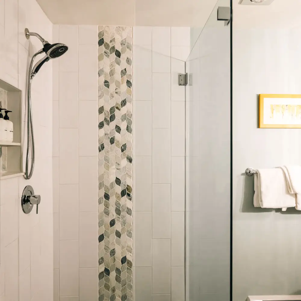 Primary bedroom's full ensuite bathroom with walk-in glass shower