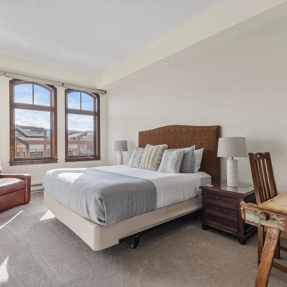 Bedroom 1 with king bed and chair that converts to twin bed